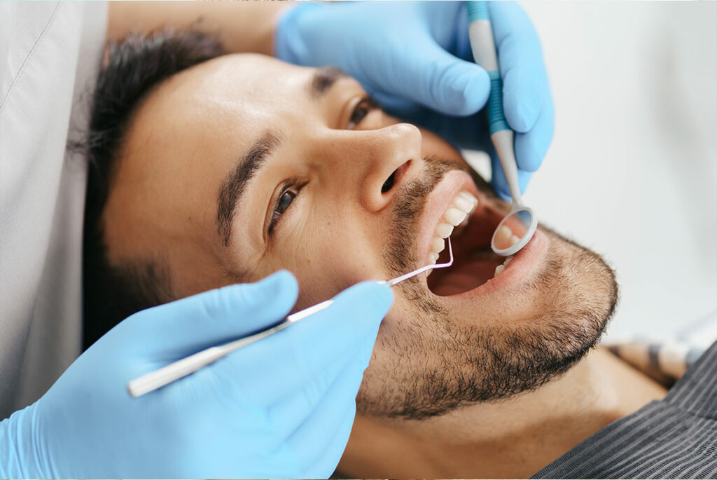 Photo of man getting teeth cleaned
